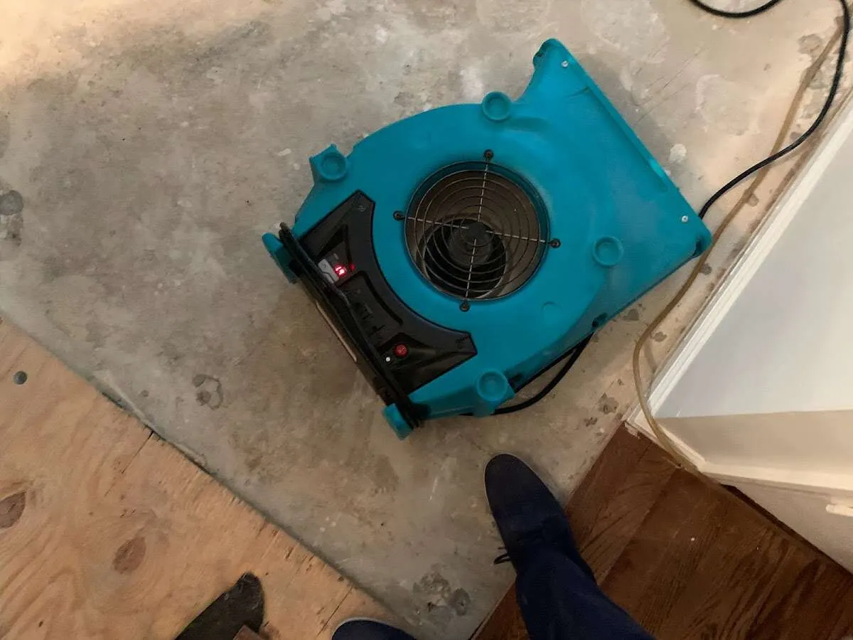 Air mover drying subfloor during Commercial Water Damage Restoration in Brewton